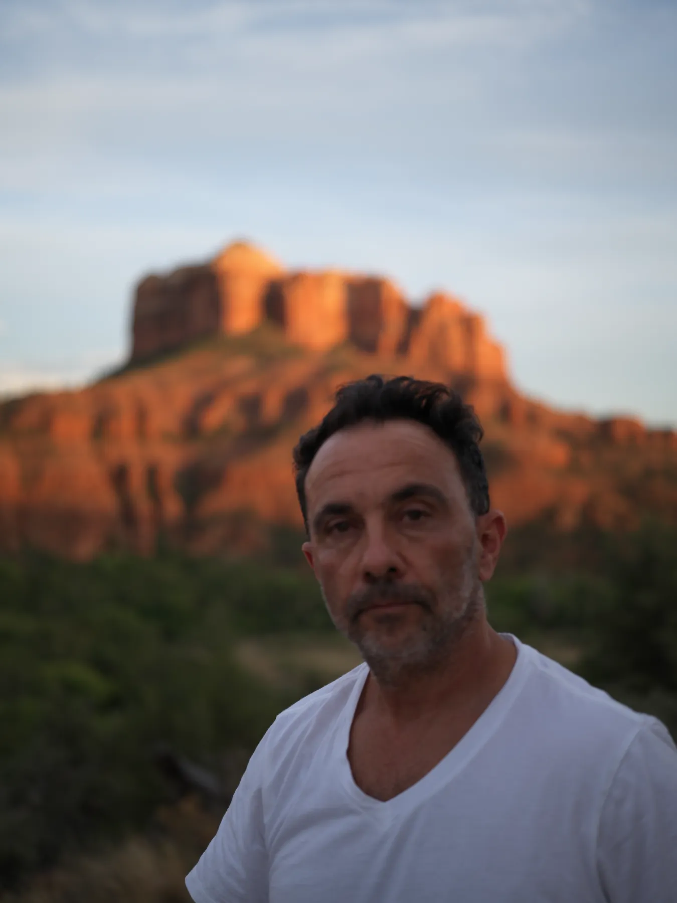 The birthday portrait. Level gaze, no performance. Fifty-six looks back.