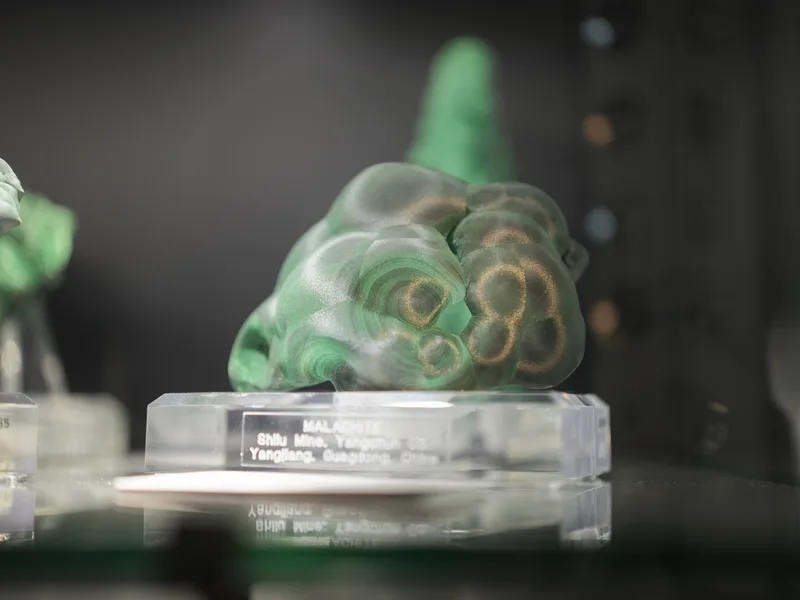 A polished botryoidal malachite specimen from the Shilu Mine, Yangchun, Yangjiang, Guangdong, China, displayed on an acr
