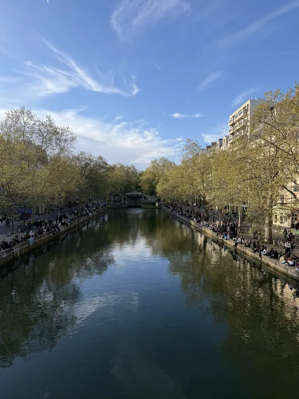 Last light on the right bank. The left in shadow. The crowds reduced to a line of color.