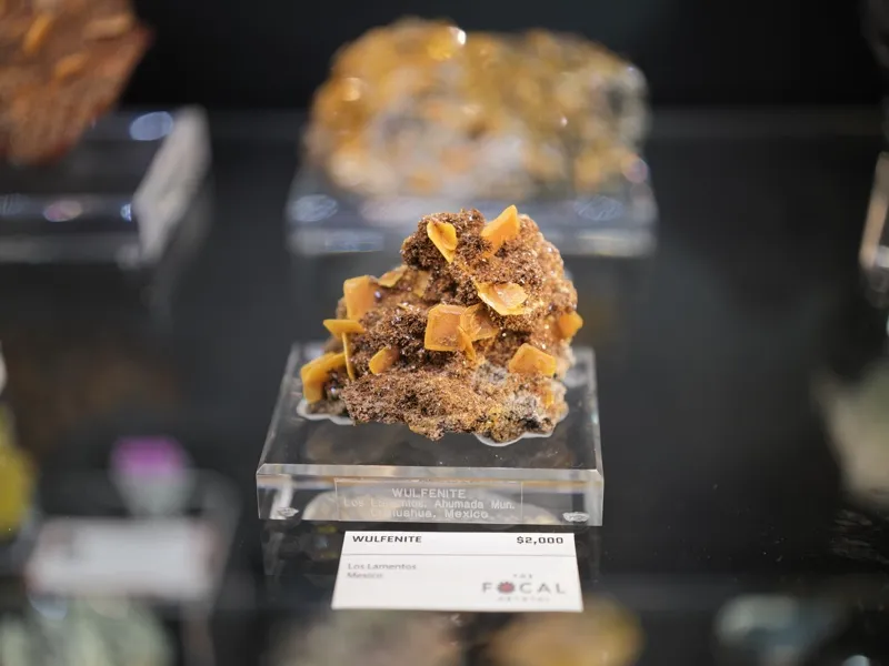 A wulfenite mineral specimen from Los Lamentos, Chihuahua, Mexico, displayed commercially in a mineral gallery at $2,000