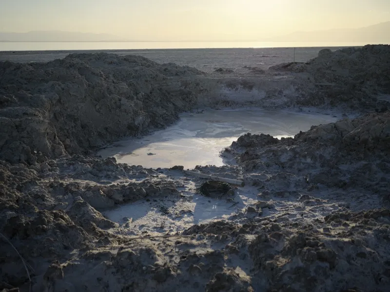 A saline crater pool — likely at the Salton Sea margin or a similar terminal basin — showing evidence of extreme mineral