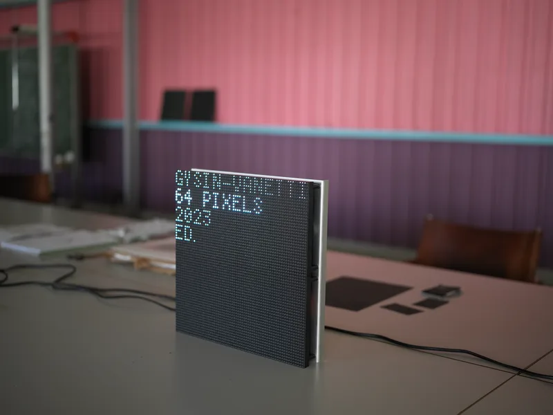 A square LED matrix display panel, self-illuminated, bearing the text 'GYSIN / 64 PIXELS / 2023 / ED.' — a reference to 